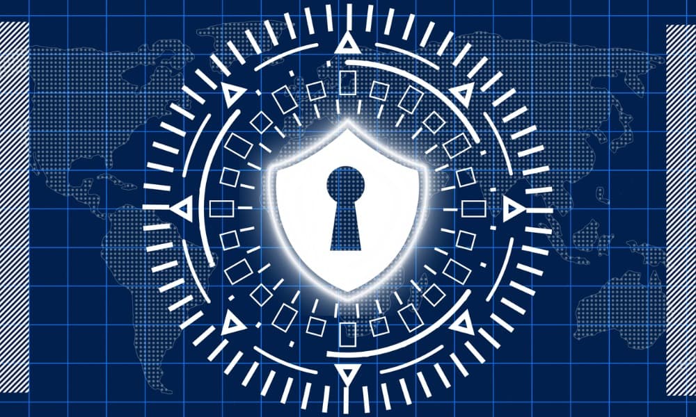 A shield with a keyhole in it, symbolizing cybersecurity, is over a blue background.