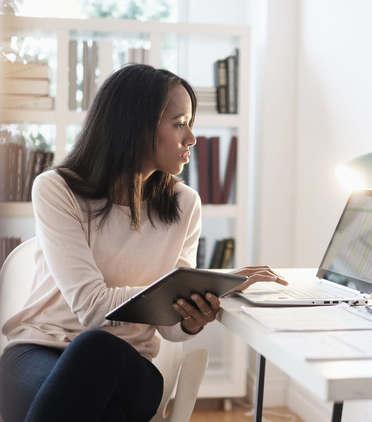 Mixed race businesswoman using laptop