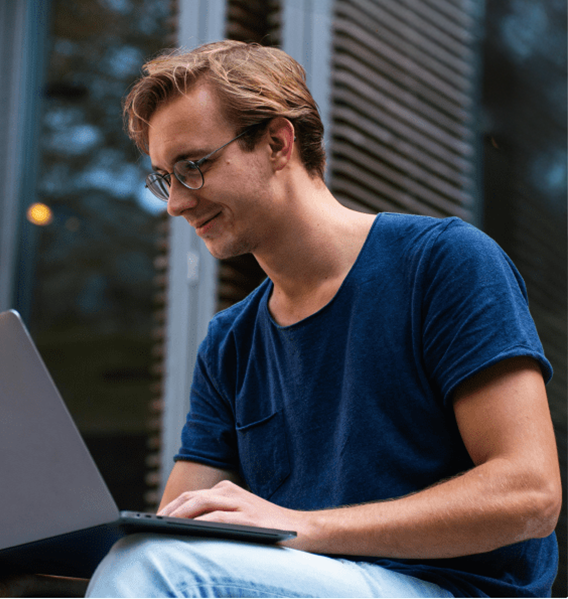 Young guy using his notebook at daylight