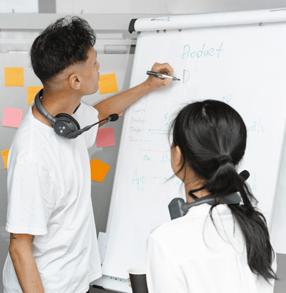 Two young people taking notes