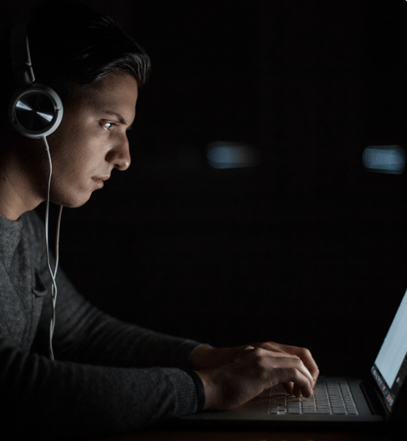 Young guy using his notebook at night